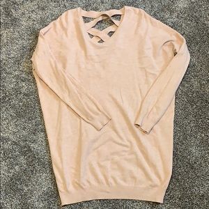 Light pink tunic sweater. Crosses in back